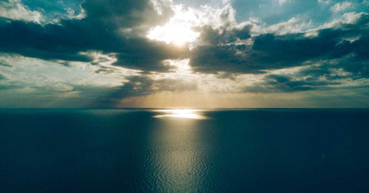 Peaceful ocean view with dramatic clouds at sunset creating a tranquil and serene seascape.